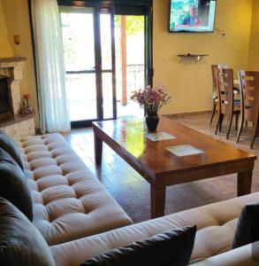 a living room with a couch and a coffee table at Alexandra Forest House in Kavála +13 photos