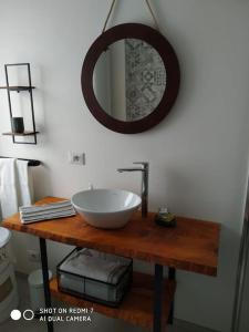 a bathroom with a sink and a mirror on a table at Casa Martina, Confort e Relax a due passi da Cividale in Cividale del Friuli