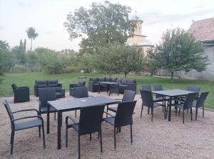 a group of tables and chairs in a yard at Casa Jisa in Turda