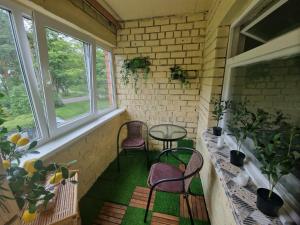 a small porch with two chairs and a table at Apartment Sepa 14 in Narva-Jõesuu