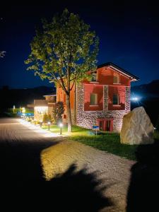 a building with a tree in front of it at night at Agriturismo Monte di Bebbio in Bebbio