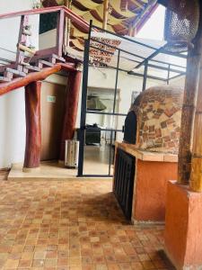 an outdoor oven in a building with a brick floor at Entre Verdes Hotel & Glamping in Medellín +136 photos
