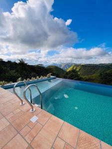 a swimming pool with a view of the mountains at TRIP MOUNT in Vagamon