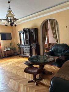 a living room with a table and a couch at Liza in Kutaisi