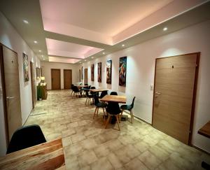 a hallway with tables and chairs in a building at BenDorma in Hannover