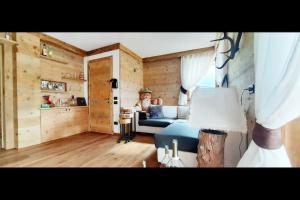 a woman is sitting on a bed in a room at 3BDRM Luxury Magic Flat near Cortina with Garage in Villanova