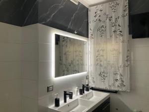 a bathroom with a sink and a mirror at Al chiaro di luna in Catania +39 photos