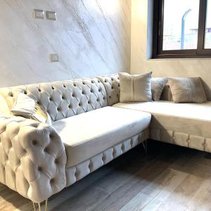 a white couch sitting in a room at Al chiaro di luna in Catania