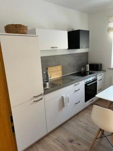 a kitchen with a white refrigerator and a sink at Urlaubshaus-Braunlage Wohnung 1 in Braunlage