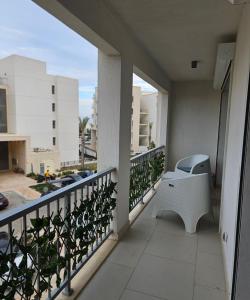 a balcony with a white bench on a building at Marassi luxury 2 bedroom in El Alamein