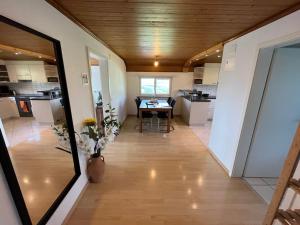a large room with a table and a kitchen at Swiss Alps in Brenzikofen