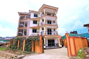 a building with an orange fence in front of it at Sarai Hotel in Fort Portal