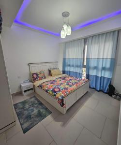 a bedroom with a bed and a blue ceiling at Marassi luxury 2 bedroom in El Alamein