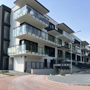 an apartment building with balconies and a driveway at Apartament Park Poezji II in Gliwice