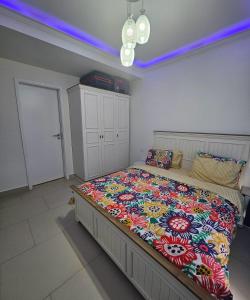 a bedroom with a large bed with a colorful blanket at Marassi luxury 2 bedroom in El Alamein