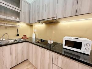 a kitchen with a microwave and a counter top at 25Studio House - District 1 in Ho Chi Minh City +15 photos