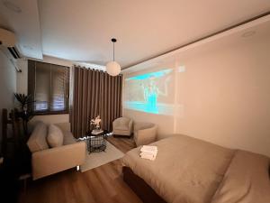 a bedroom with a bed and a large screen at 25Studio House - District 1 in Ho Chi Minh City