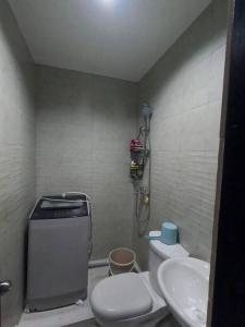 a small bathroom with a toilet and a sink at Duplex House for Rent with 3 Bedrooms good for 6 in Minglanilla