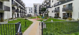 an apartment complex with a walkway between two buildings at Ozas Park Apartments in Vilnius