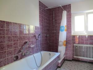 a bathroom with a tub and a window at Gästehaus Erika in Tengen +35 photos