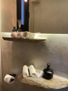a bathroom with a shelf with towels and a sink at The forest chalet in Parnassus in Eptalofos +43 photos