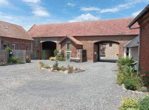 a house with a red roof and a driveway at Les muches in Bouzincourt