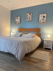 a bedroom with a large bed with two pillows at Les muches in Bouzincourt