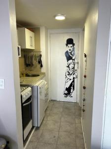a kitchen with a door with a painting on it at seeblickcenter in San Carlos de Bariloche