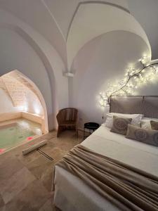 a bedroom with a bed and a swimming pool at Zahra Superior Suite with private pool in Sannicola +52 photos