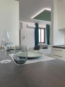 a table with a plate and a glass on it at Green House tra natura e città in Vedano al Lambro +8 photos
