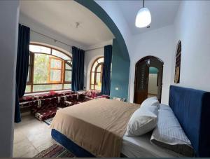 a bedroom with a large bed and a large window at Revesta dahshur in Minshāt Dahshūr
