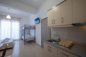 a small kitchen with a sink and a sink at Vila Flamuri in Sarandë