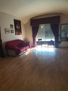 a living room with a couch and a table at Beautiful spacious house with swimming pool in Limassol