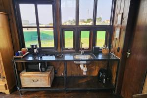 a bathroom with a sink and a window at Recanto AlceNegro in Miguel Pereira