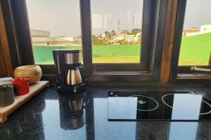 a coffee maker sitting on a table next to a window at Recanto AlceNegro in Miguel Pereira