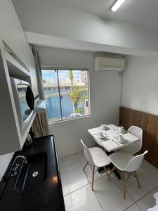 a small dining room with a table and chairs at Flat Sol in Balneário Camboriú