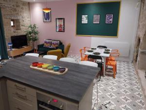 a living room with a table with paints on it at Maison centre historique Figeac in Figeac