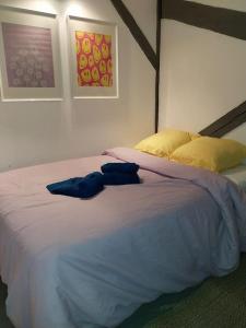 a bedroom with a large bed with two pillows at Maison centre historique Figeac in Figeac