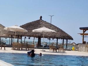 a group of people in the swimming pool at a resort at Durres Sun & Sea Luxury Apartment in Durrës