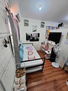 a small room with a bed and a desk at Homey Inn-Olango Island Staycation ,block 1 lot 15 in Lapu Lapu City