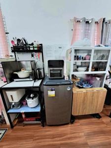 a kitchen with a refrigerator and a counter with food at Homey Inn-Olango Island Staycation ,block 1 lot 15 in Lapu Lapu City