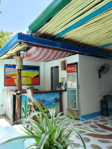 a restaurant with a counter with a colorful painting at Casa Montemar Heights in Coron