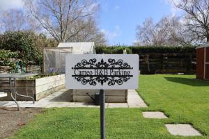 a sign in the yard of a garden at Cameo B&B in Matamata +5 photos
