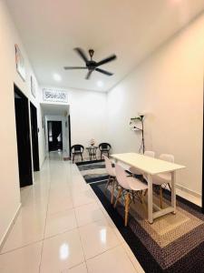 a dining room with a white table and chairs at AM Homestay Kijal in Kemaman +13 photos