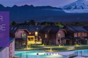 a group of houses with a mountain in the background at Edificio Costa Pucón a pasos del Lago in Pucón