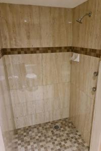 a bathroom with a shower with a tiled floor at Hotel Arcadia Cuernavaca in Cuernavaca +22 photos