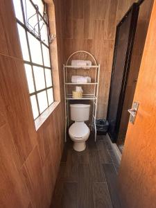 a bathroom with a white toilet in a room at Vista Reforma in Guanajuato