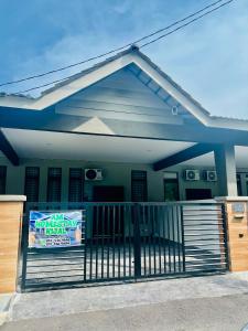 a house with a sign on the front porch at AM Homestay Kijal in Kemaman