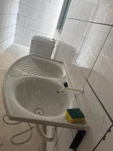 a bathroom sink with a scrub brush and a sponge at Casa com Piscina individual in Paulista +6 photos