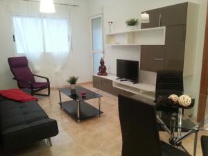 a living room with a couch and a tv at Apartment Huerto in Torrevieja